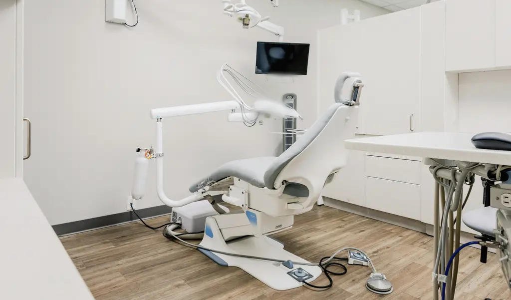 An empty dental treatment room, the chair at rest