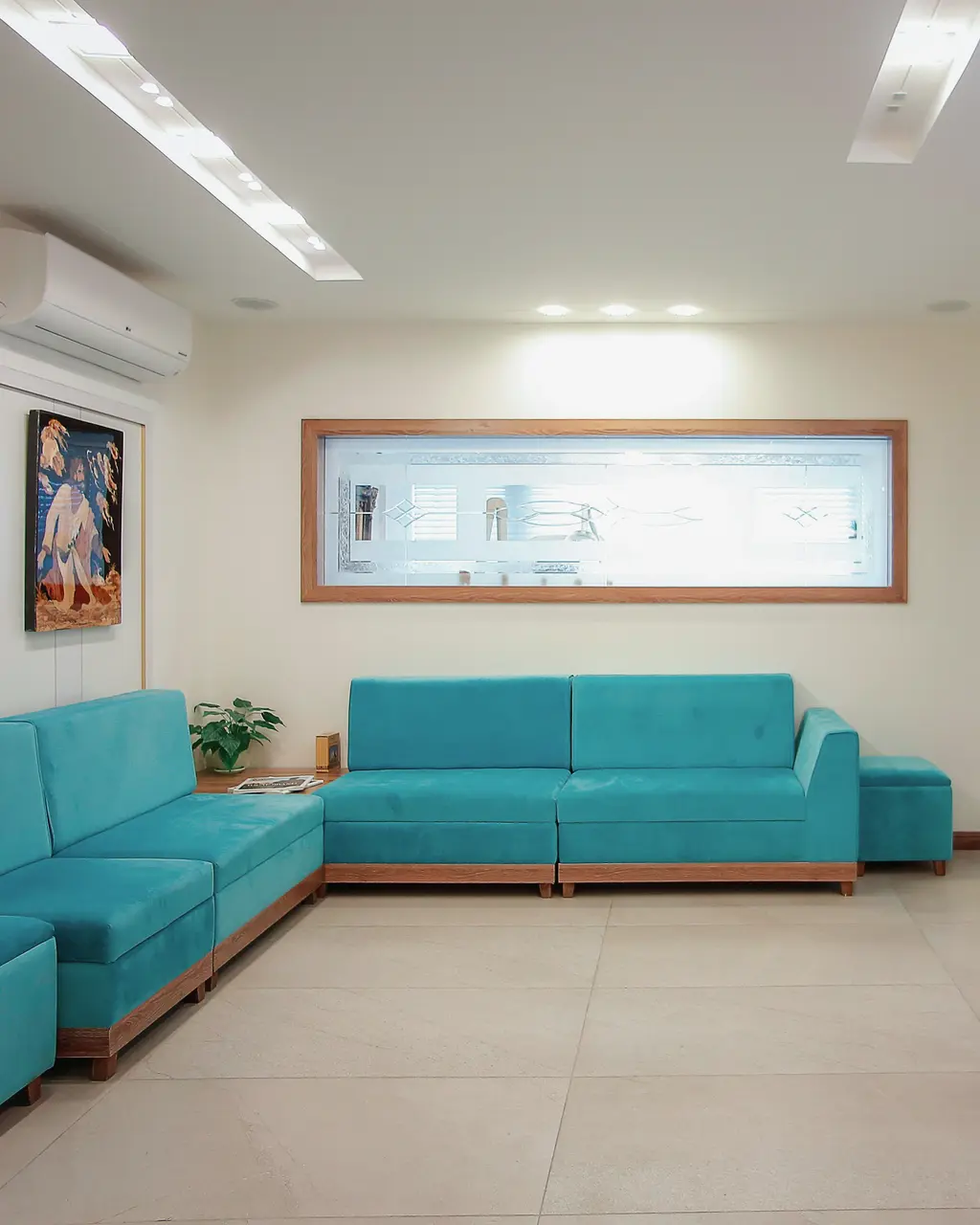 A clinic waiting room with blue sofas