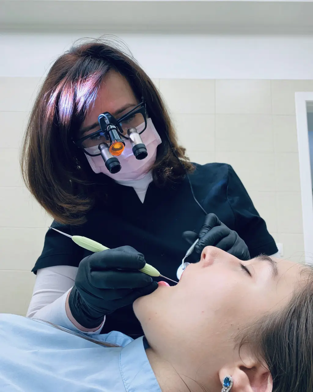 A dentist with magnifying loupes at work
